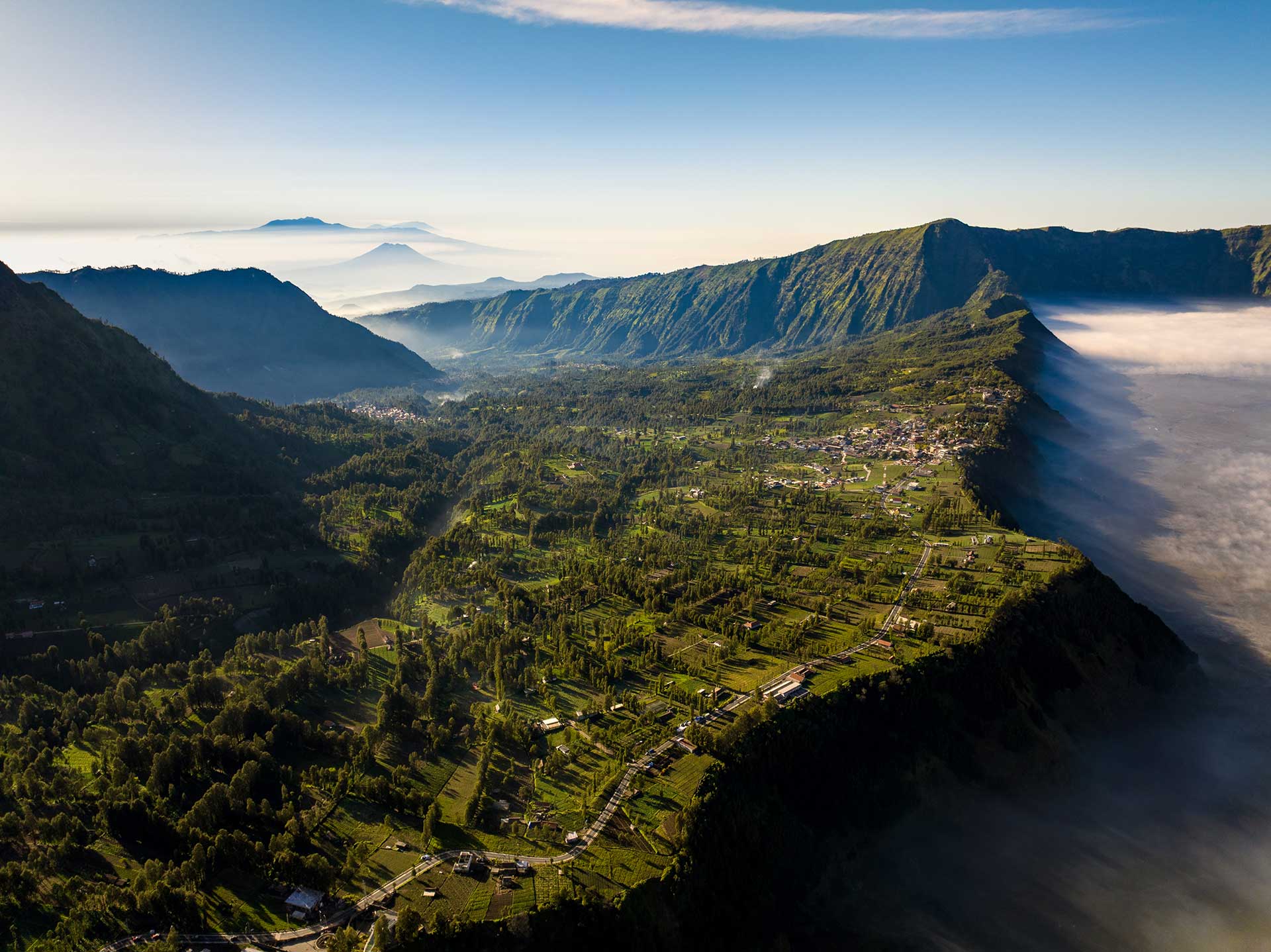 village-and-cliff-at-bromo-volcano-in-tengger-seme-2024-12-04-11-08-42-utc